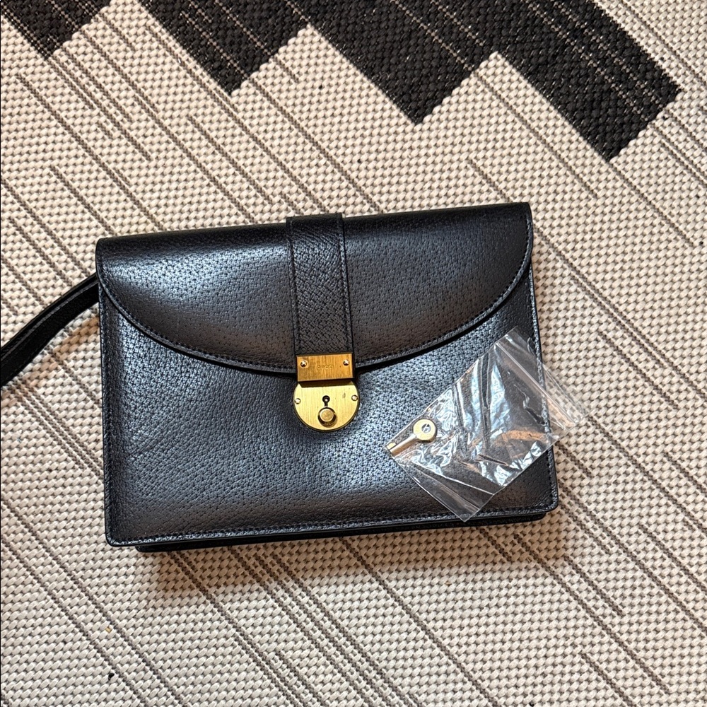 Gucci Elegant Black Clutch with Gold Accent